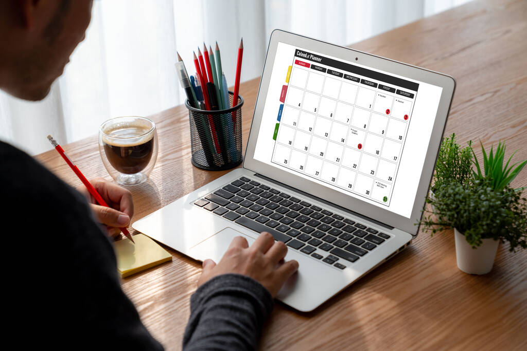 computer with calendar to find dates for cheap business class flights