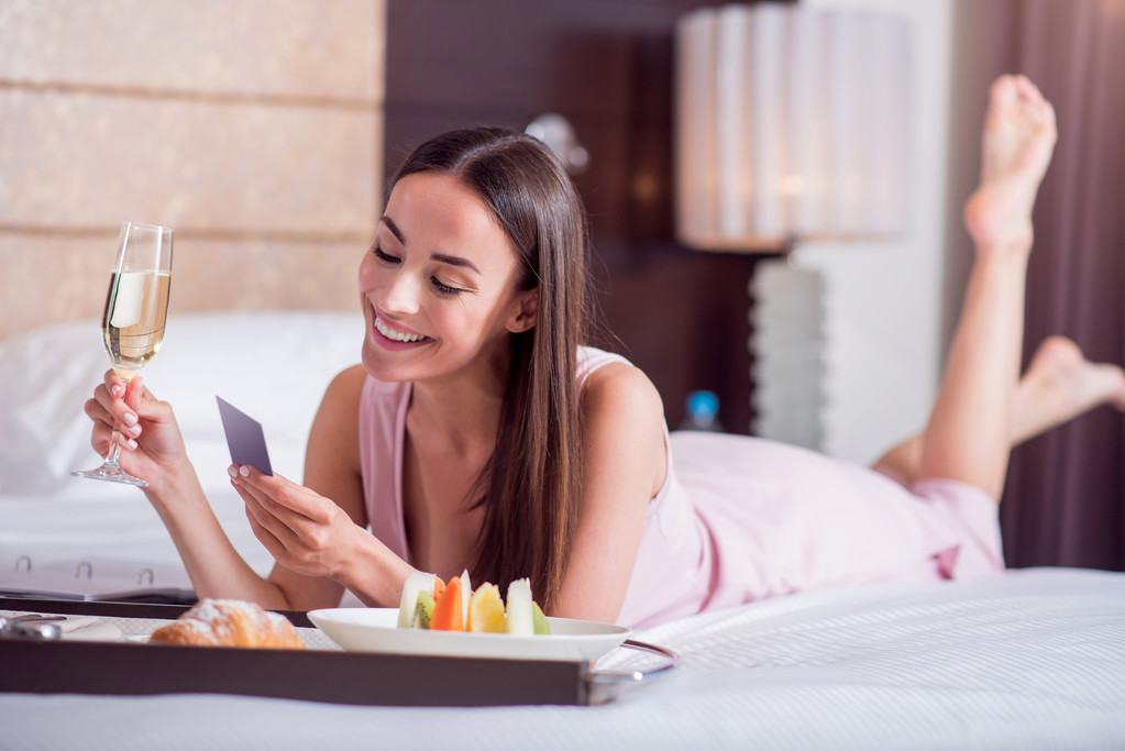 pretty girl on bed with room service