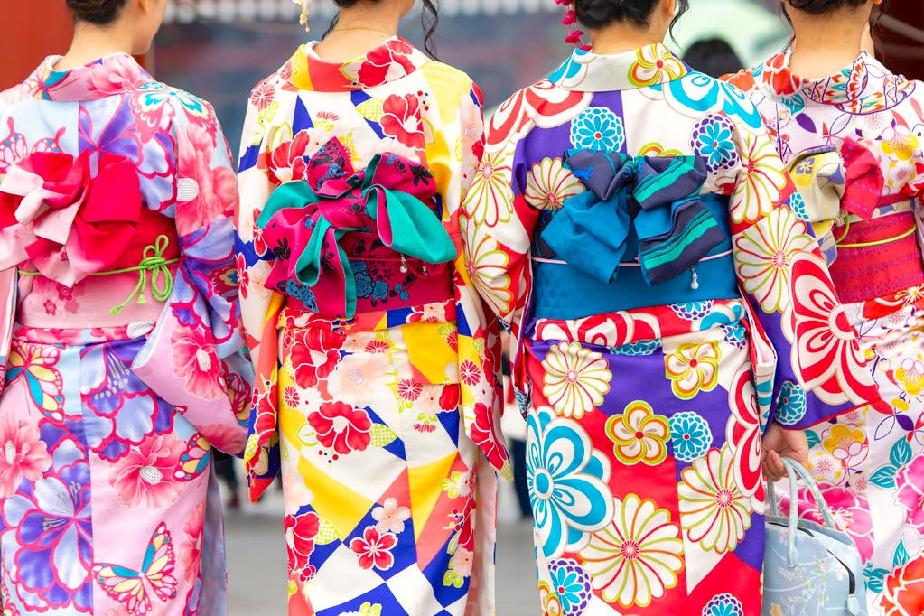 Young girl wearing Japanese kimono standing in front of Sensoji Temple in Tokyo, Japan. Kimono is a Japanese traditional garment. The word "kimono", which actually means a "thing to wear"