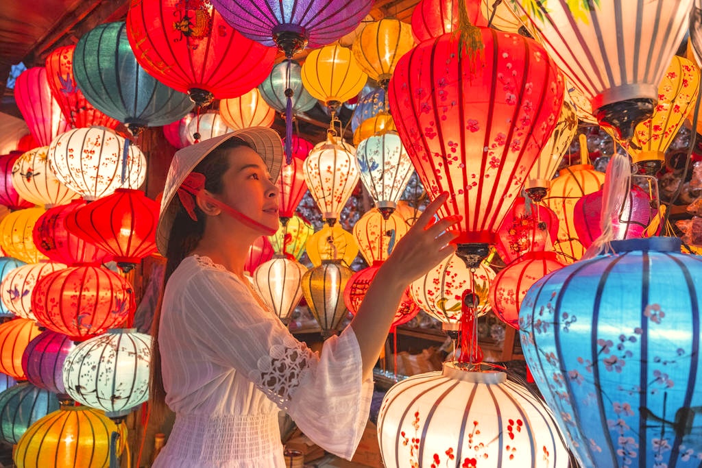 Travel woman choosing lanterns in Hoi An, Vietnam